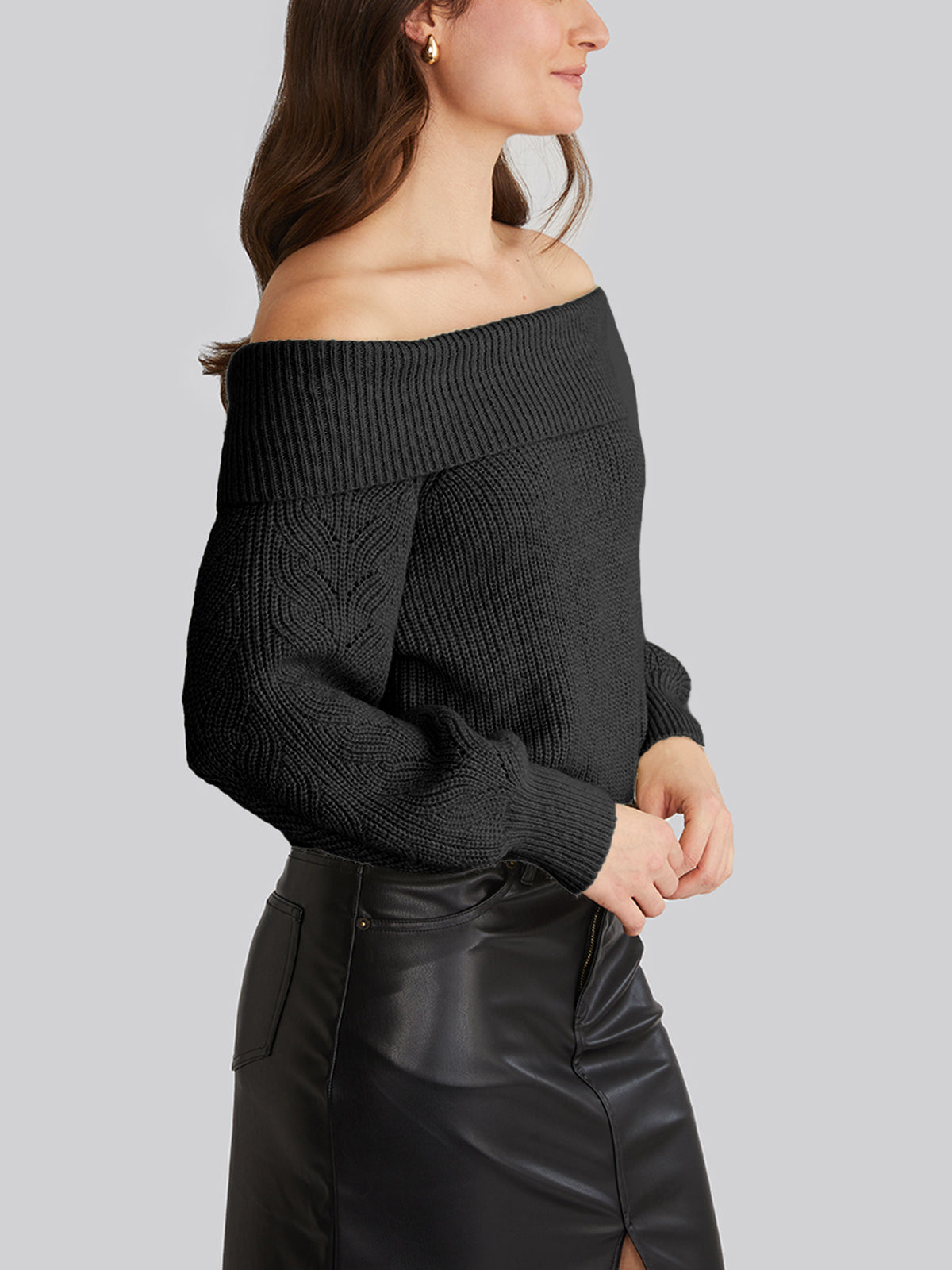 Dressed in a chic 525 America off-shoulder black knit top, paired with a high-waisted black leather skirt featuring a front slit, they stand poised against a plain gray background. Their long hair cascading elegantly, theyre perfectly styled for casual outings.