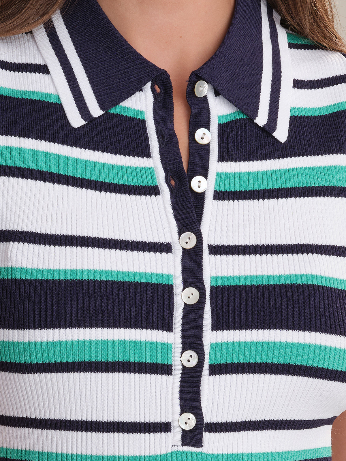 Close-up of a person wearing a 525 America ribbed knit shirt with nautical navy blue, white, and green stripes, a navy blue collar, and white front buttons.