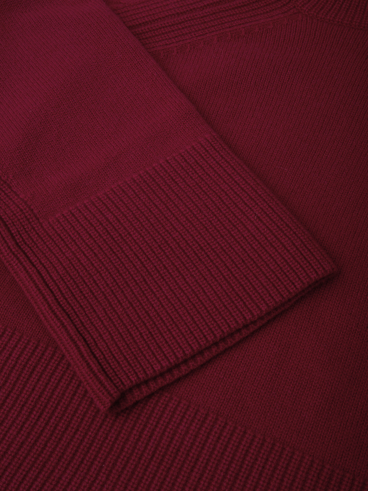 Close-up of a burgundy sweater with ribbed texture