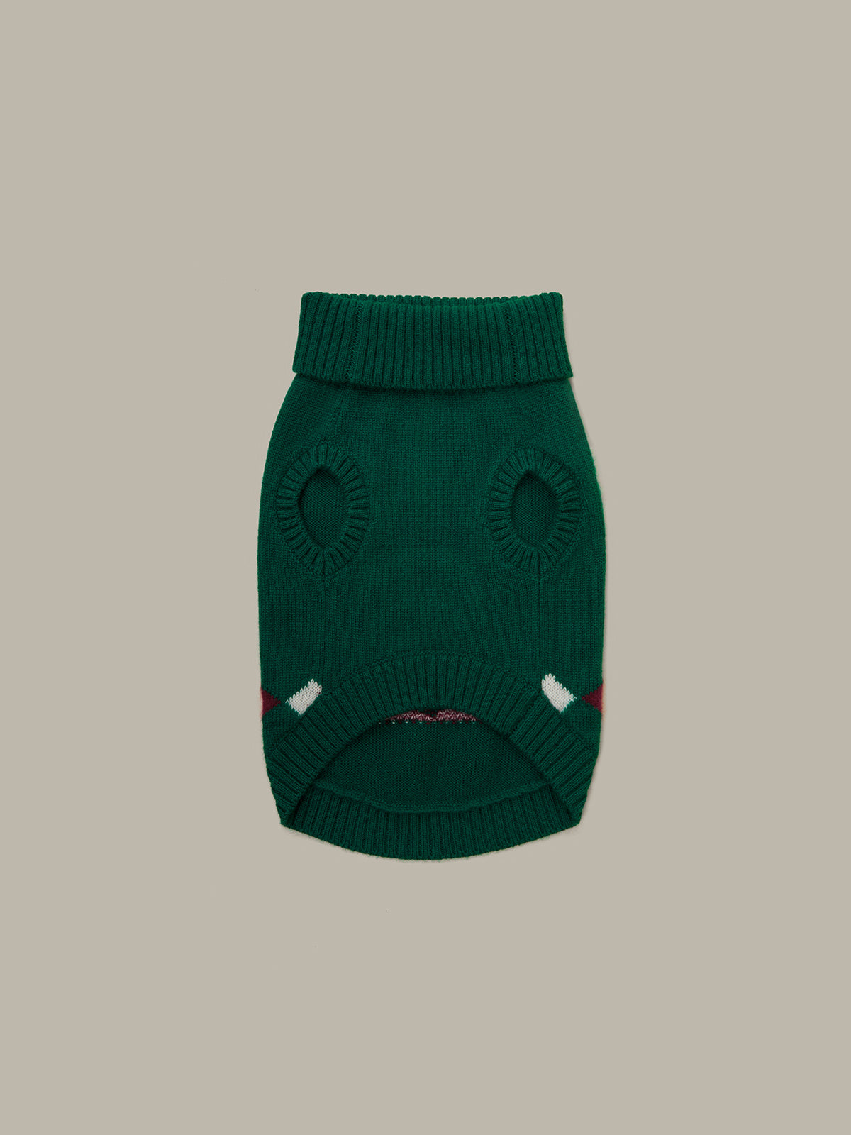 Green knitted dog sweater on a beige background