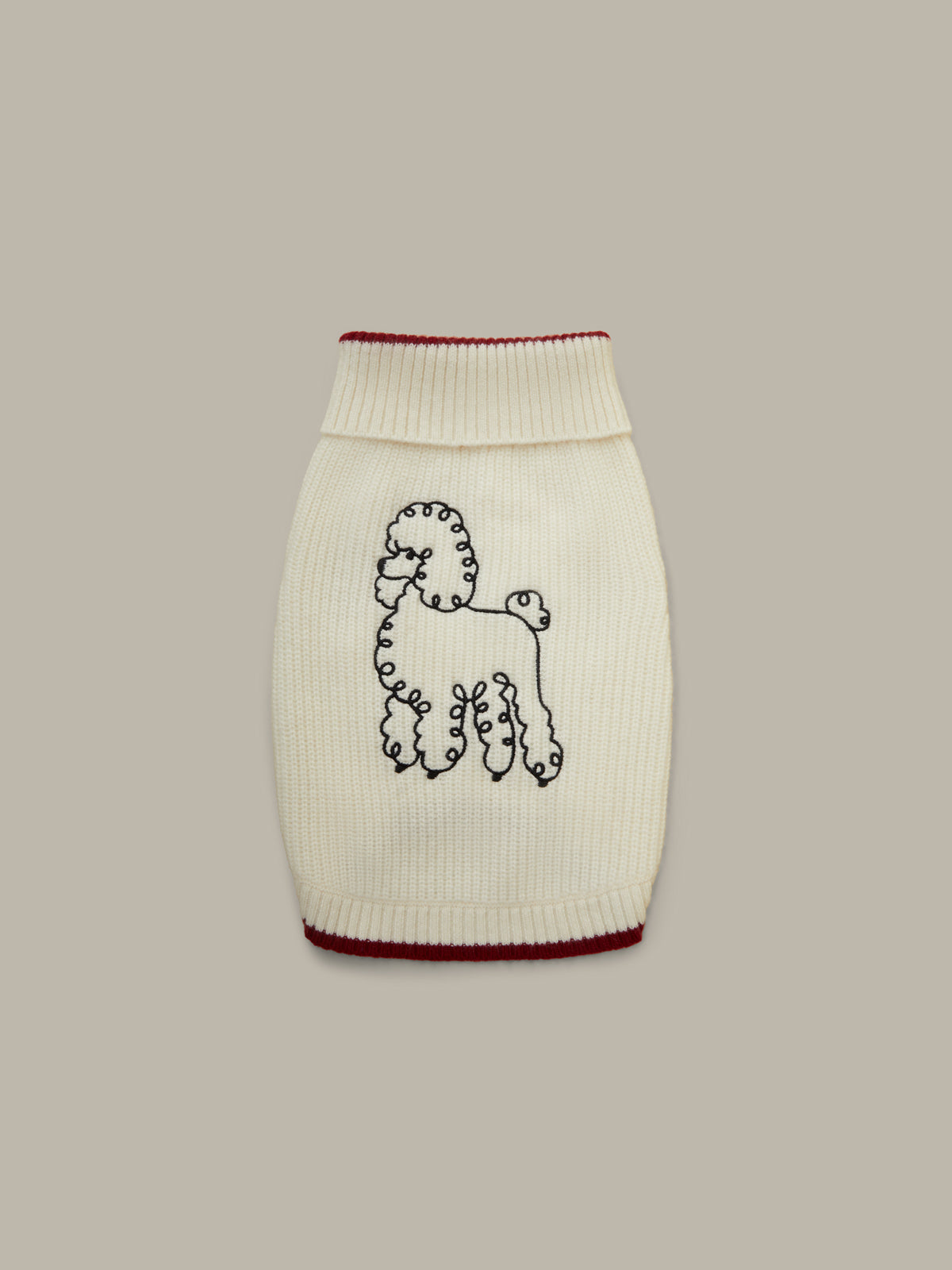 Knitted dog sweater with a dog design on a beige background