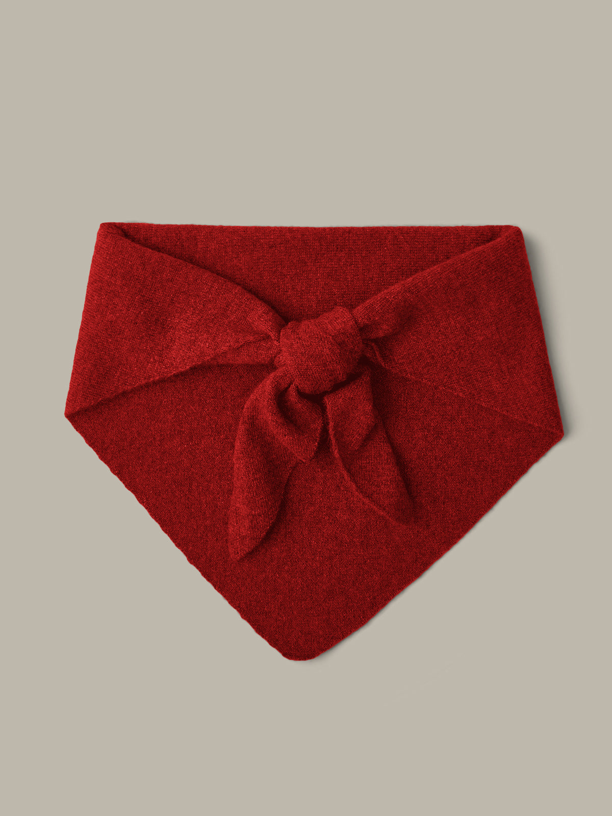 Red headband with a bow on a beige background