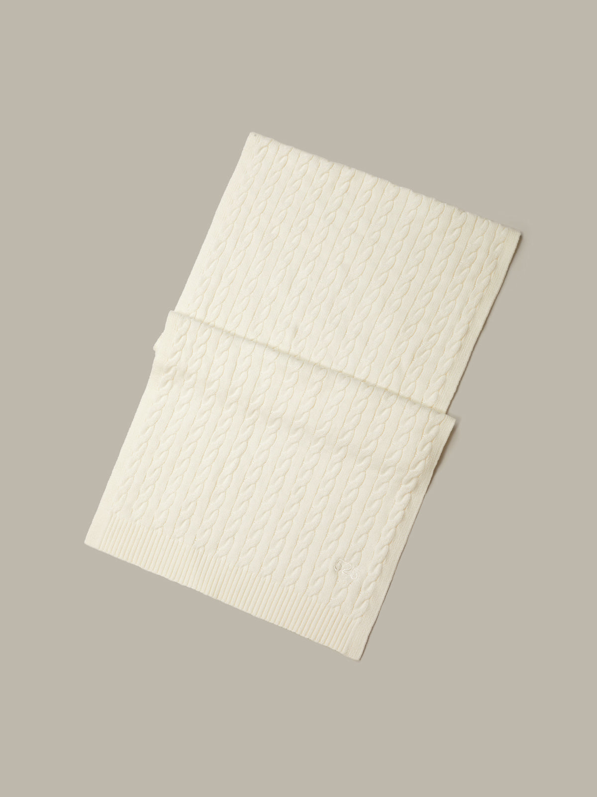 Two textured white sheets on a beige background