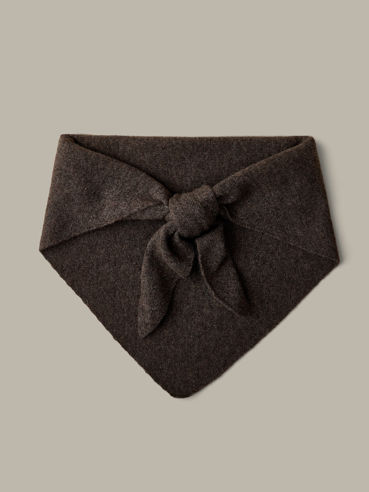 Brown fabric bandana with a knot on a beige background