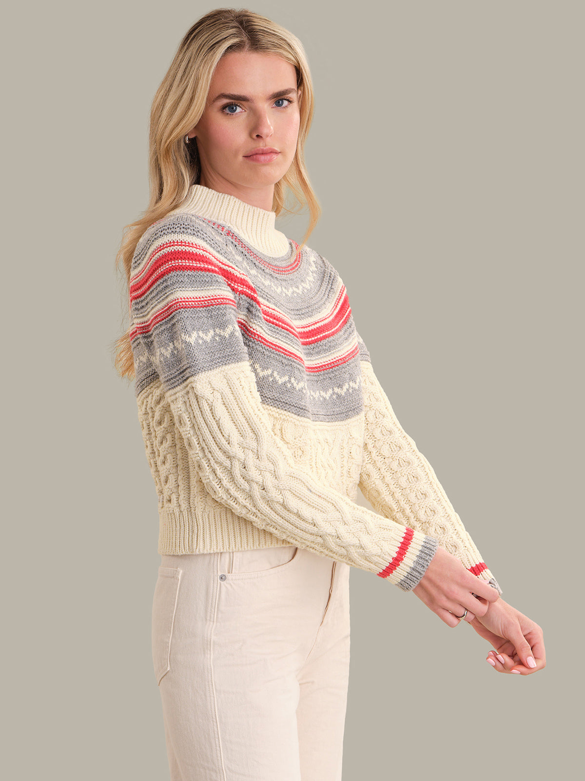 Woman wearing a patterned sweater with a neutral background