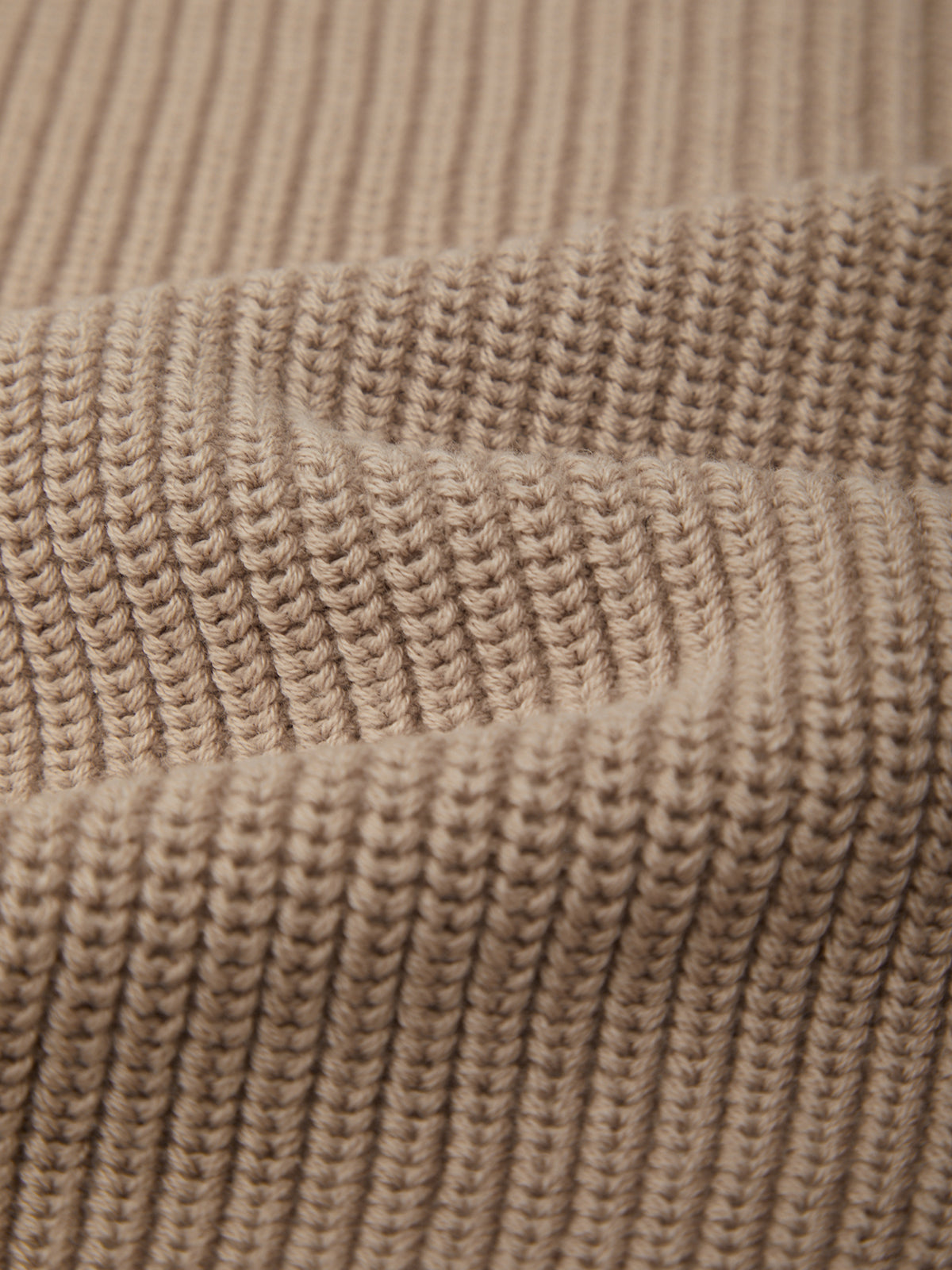 Close-up of a textured beige fabric surface
