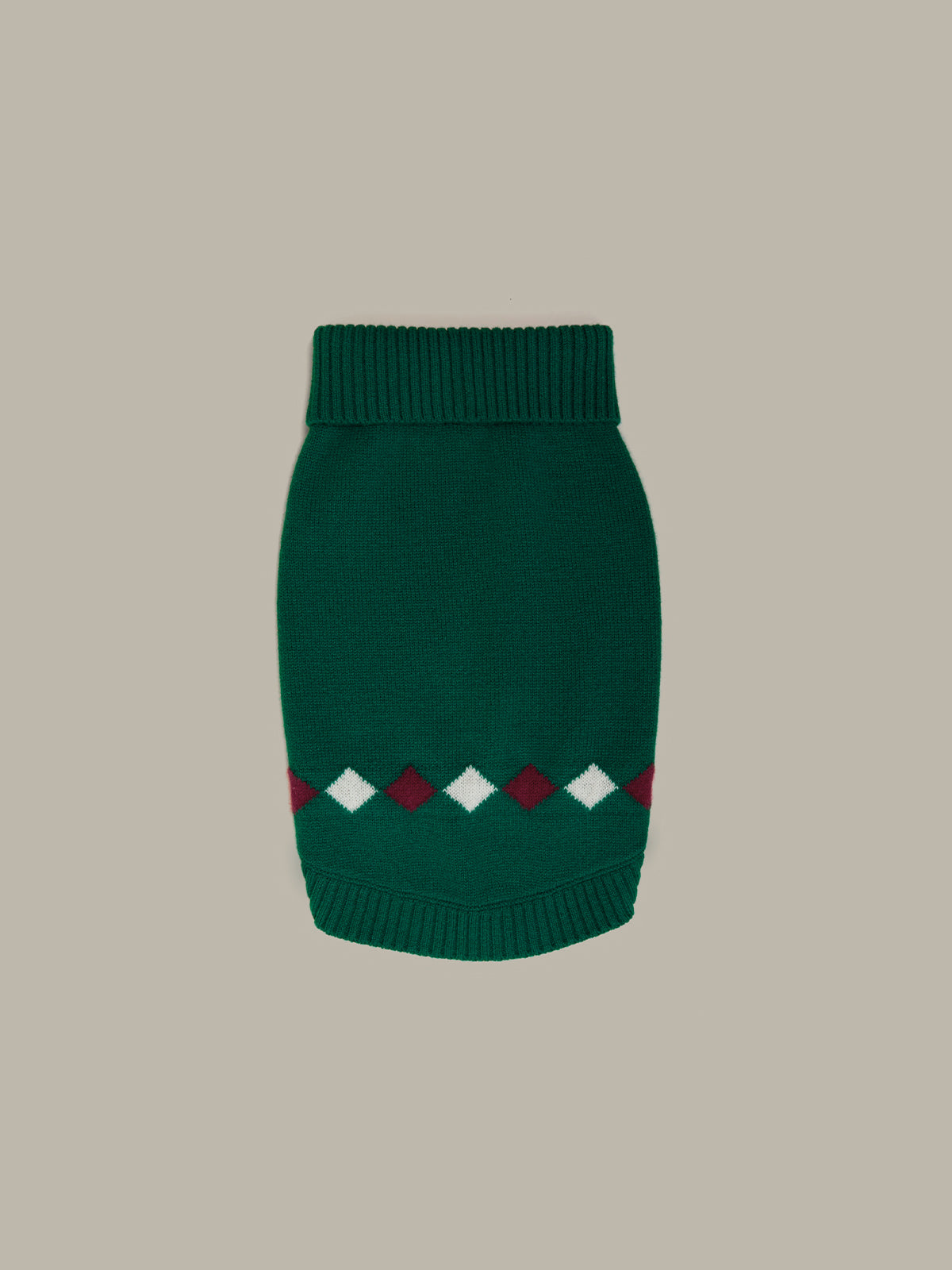 Green knitted dog sweater with diamond pattern on a beige background