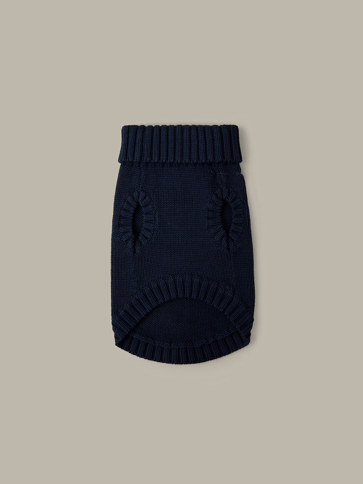 Navy blue knitted dog sweater on a beige background