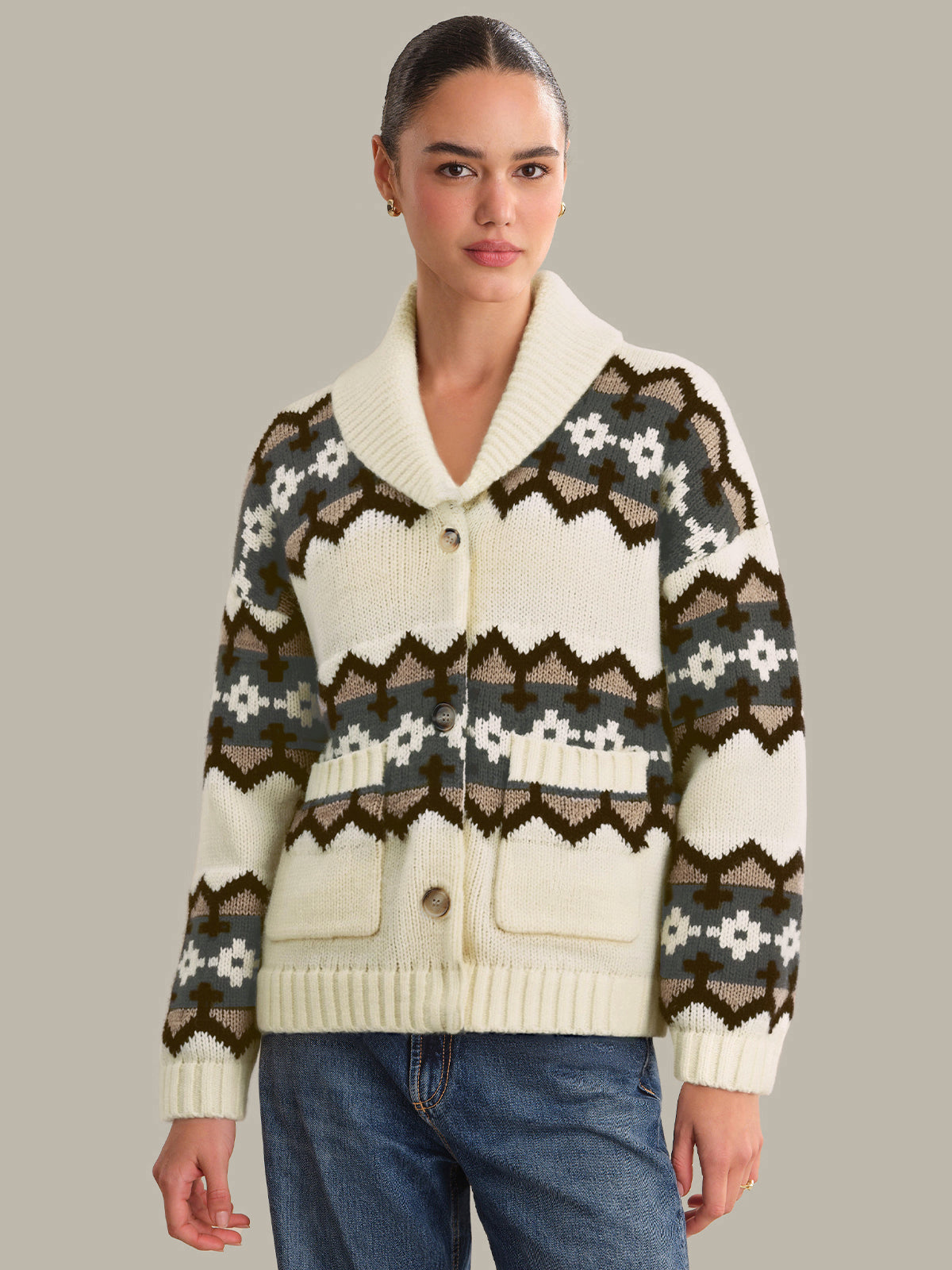 Woman wearing a patterned cardigan with a neutral background