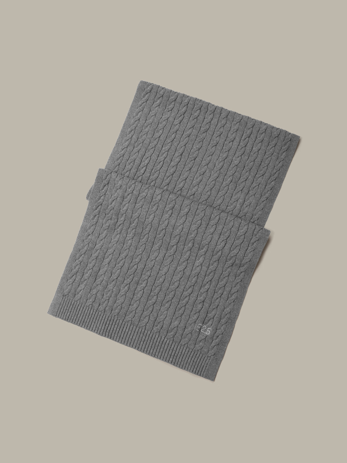 Gray ribbed knit scarf on a beige background